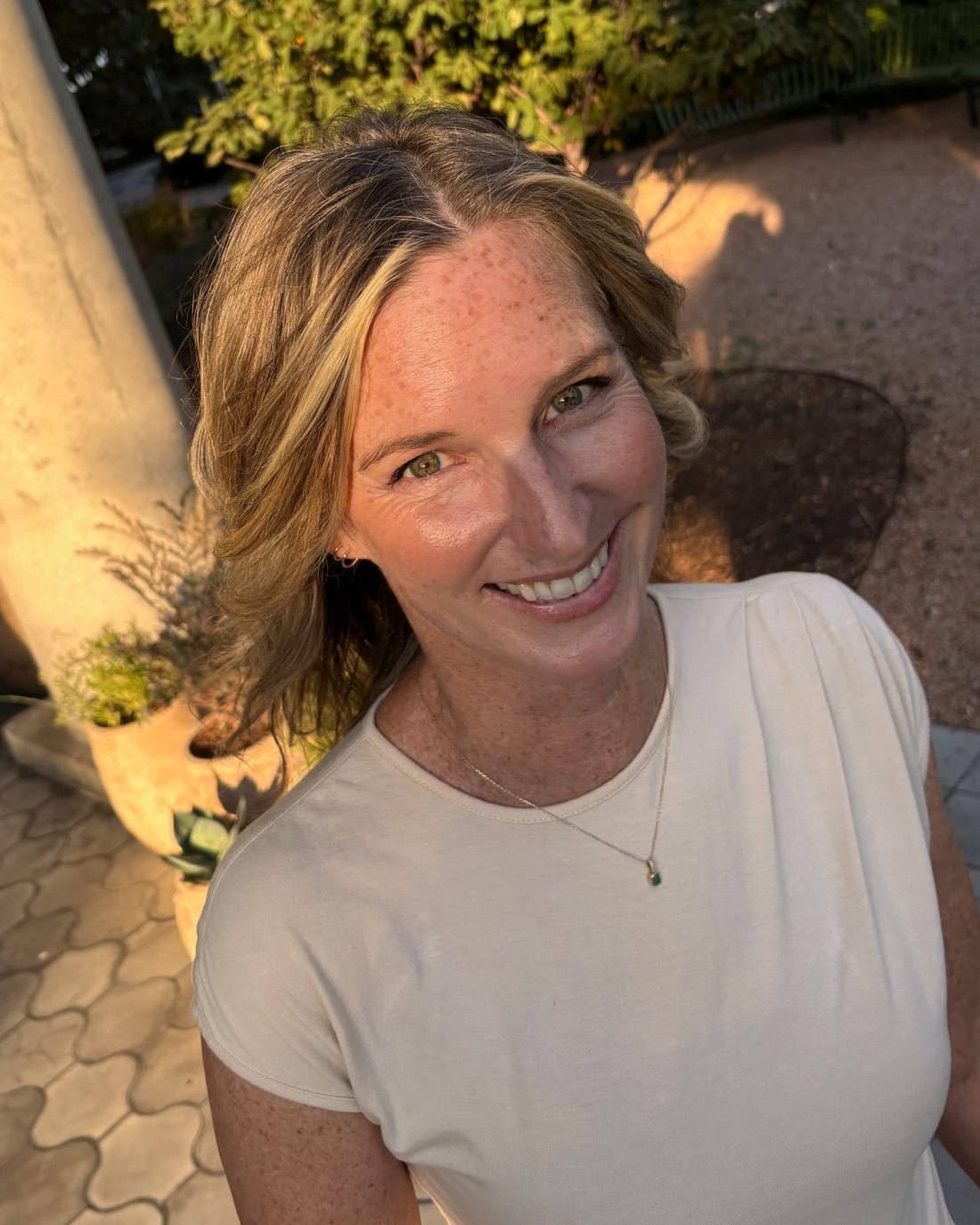 Heather MacLaren smiling outdoors in golden evening light